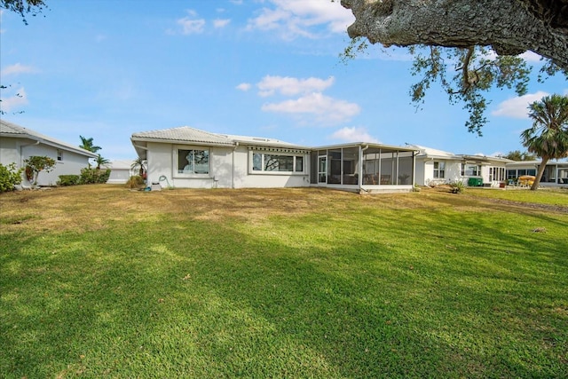 back of house featuring a sunroom and a yard