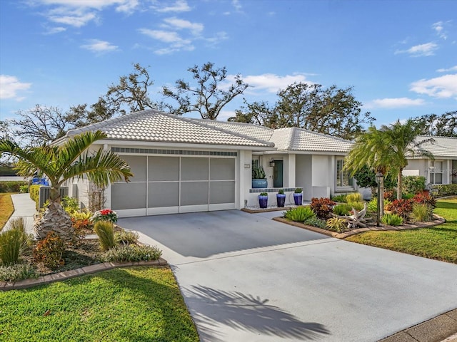 single story home featuring a garage and a front yard