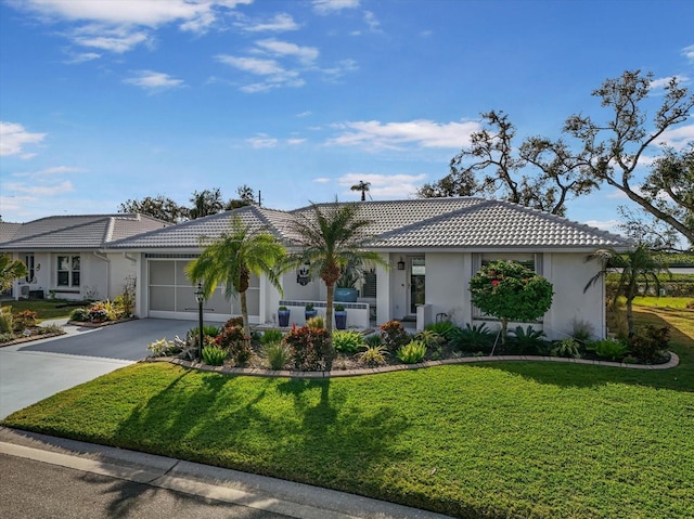 single story home featuring a front yard and a garage