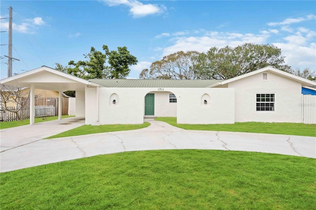 ranch-style home featuring a front yard and a carport