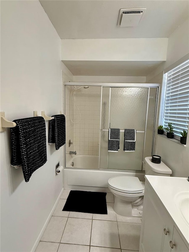 full bathroom featuring tile patterned flooring, vanity, toilet, and shower / bath combination with glass door