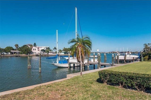 dock area featuring a water view and a lawn