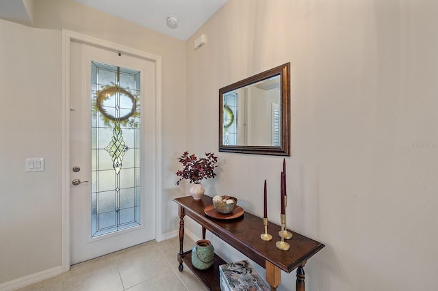 entrance foyer featuring light tile patterned floors and plenty of natural light