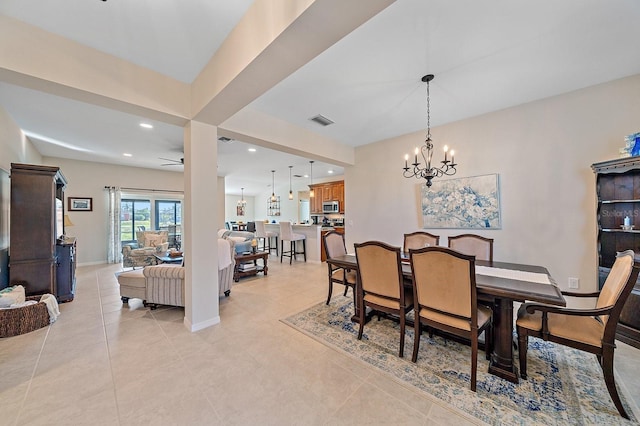 tiled dining area with ceiling fan with notable chandelier