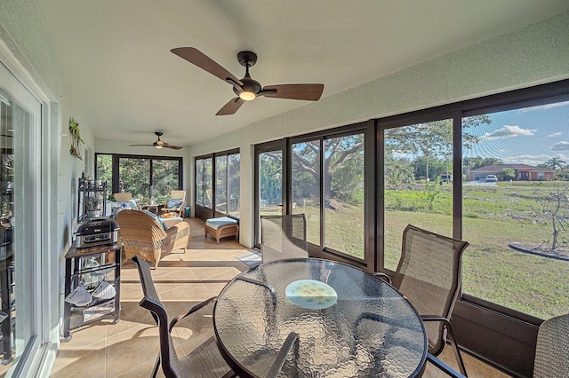 sunroom featuring ceiling fan