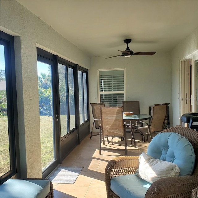 sunroom / solarium featuring ceiling fan