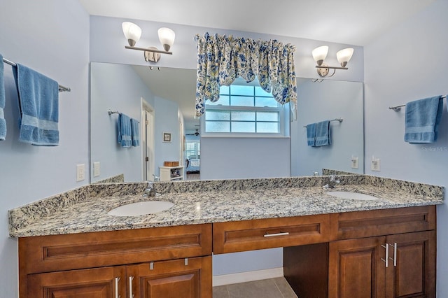 bathroom featuring vanity, an inviting chandelier, and tile patterned floors