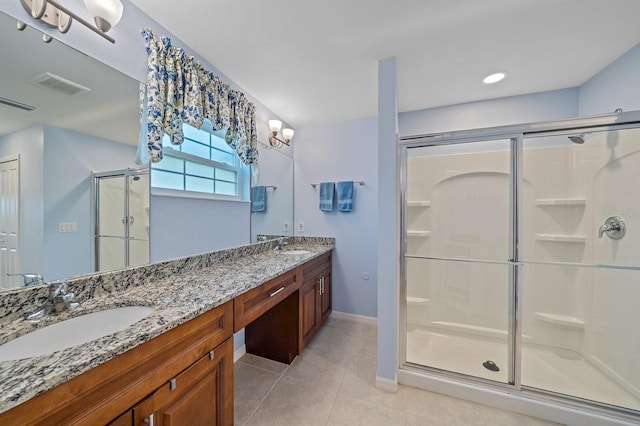 bathroom with tile patterned floors, vanity, and an enclosed shower