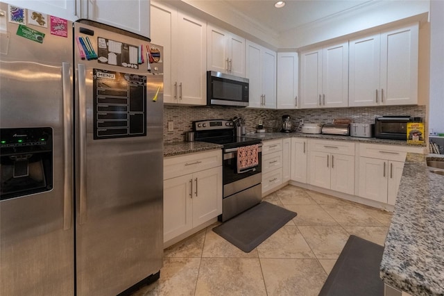 kitchen featuring white cabinets, stainless steel appliances, light stone counters, and tasteful backsplash