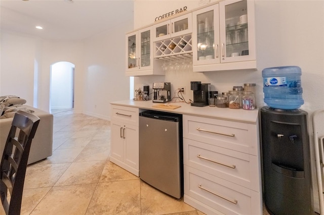 kitchen featuring refrigerator, white cabinets, and light tile patterned floors