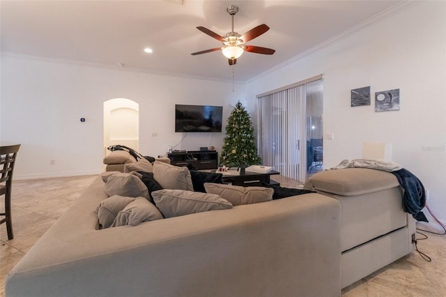 living room featuring ceiling fan, light tile patterned floors, and crown molding