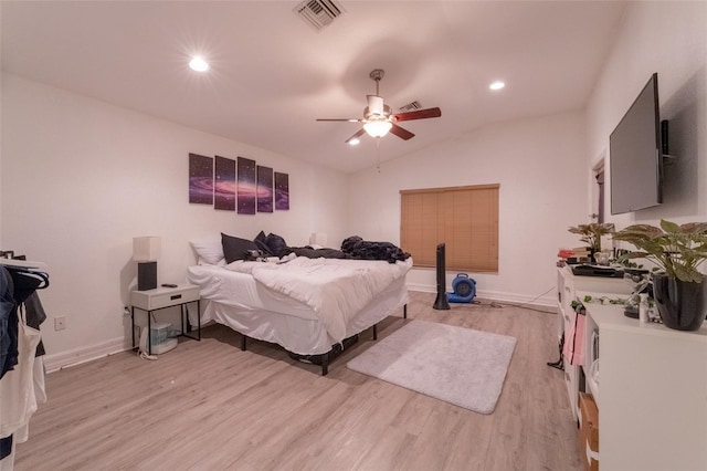 bedroom with ceiling fan, light hardwood / wood-style flooring, and vaulted ceiling