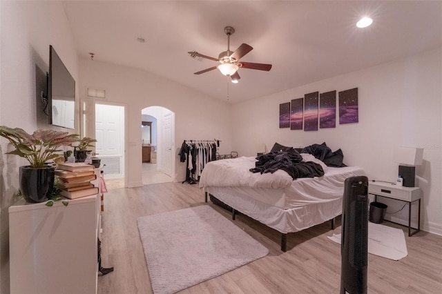 bedroom featuring ceiling fan, light wood-type flooring, and connected bathroom