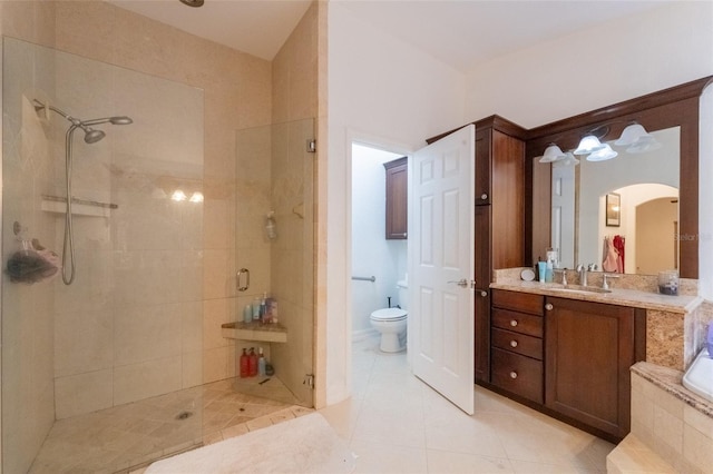 full bathroom featuring tile patterned floors, vanity, plus walk in shower, and toilet