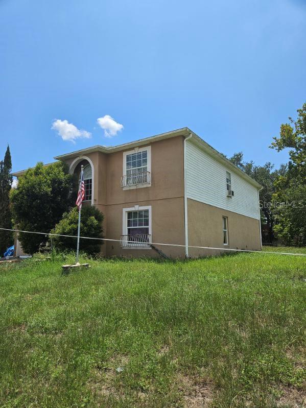 view of side of home with a lawn