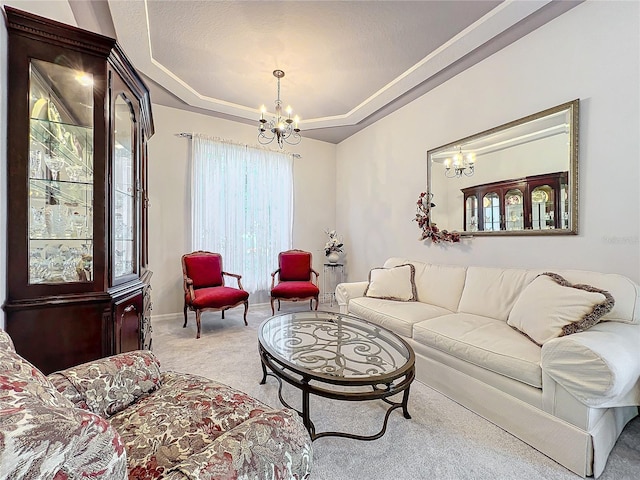 carpeted living room featuring a tray ceiling and an inviting chandelier