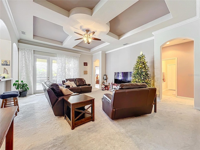 living room featuring french doors, ornamental molding, coffered ceiling, light colored carpet, and ceiling fan