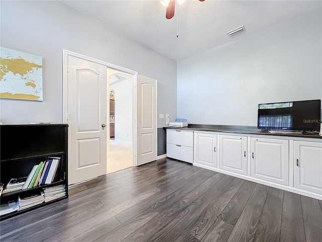 interior space with ceiling fan and dark hardwood / wood-style flooring