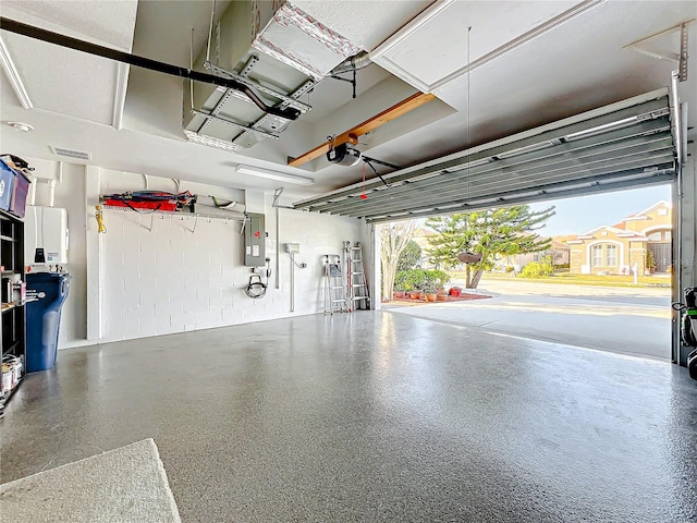 garage featuring electric panel and a garage door opener