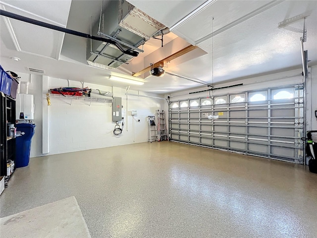 garage with electric panel and a garage door opener