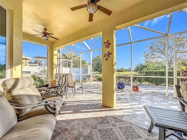 sunroom featuring ceiling fan