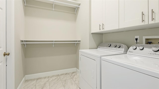 washroom featuring marble finish floor, independent washer and dryer, cabinet space, and baseboards