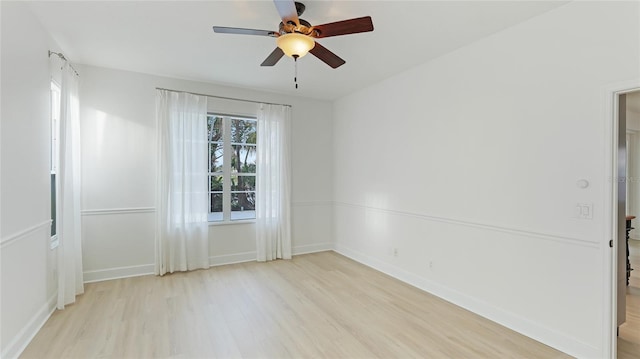 empty room with light wood-style floors, ceiling fan, and baseboards