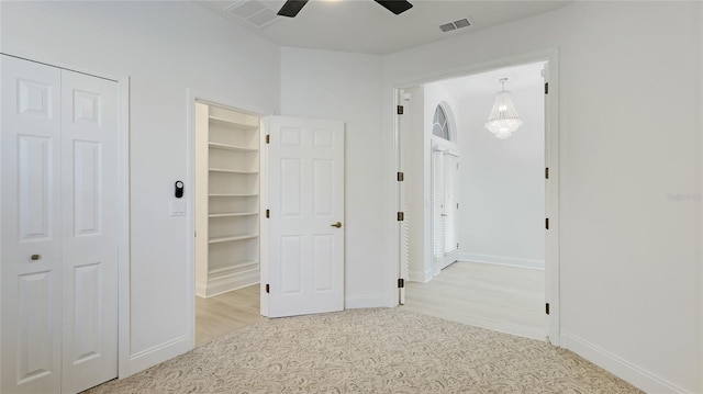 unfurnished bedroom featuring light carpet, baseboards, visible vents, a ceiling fan, and a closet