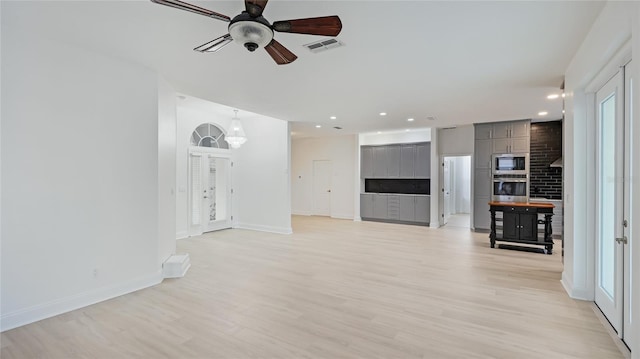 unfurnished living room with recessed lighting, visible vents, baseboards, a ceiling fan, and light wood-type flooring