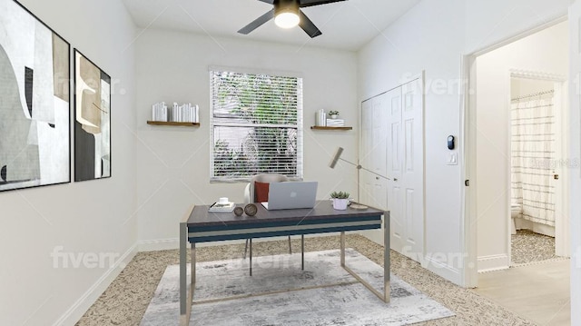 office space with ceiling fan and baseboards