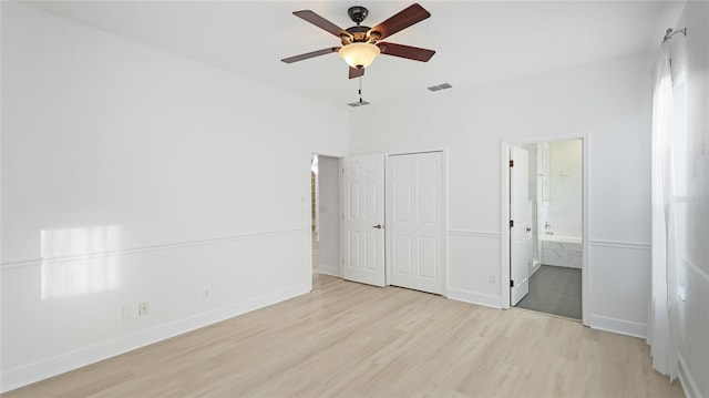 unfurnished bedroom with visible vents, baseboards, ensuite bath, light wood-style flooring, and ceiling fan