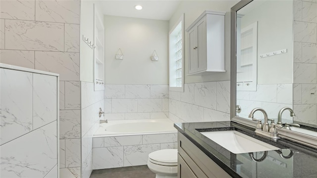 full bath featuring a bath, toilet, tile walls, and vanity