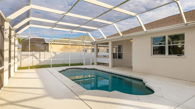 view of pool with a patio area, fence, a fenced in pool, and a lanai