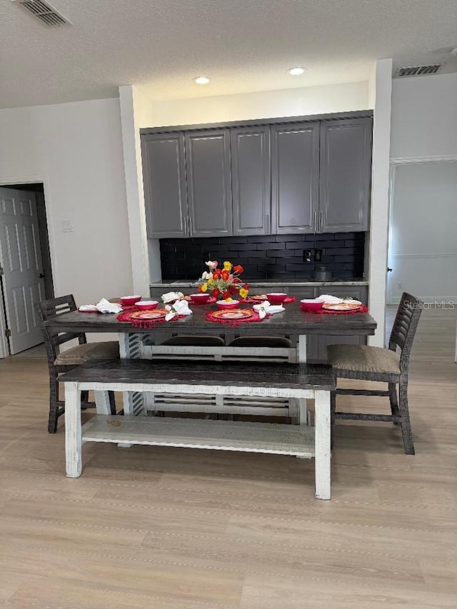 dining area featuring visible vents and light wood-style floors