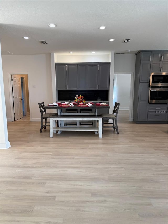 dining room featuring light wood finished floors, visible vents, and recessed lighting