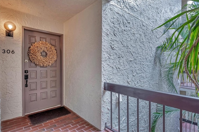 entrance to property with a balcony