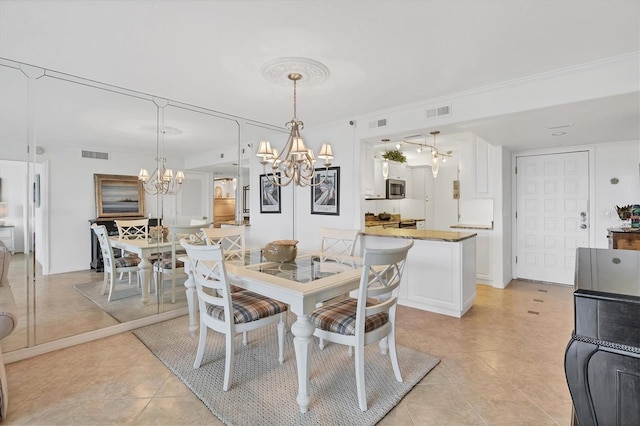 dining room with light tile patterned flooring and an inviting chandelier