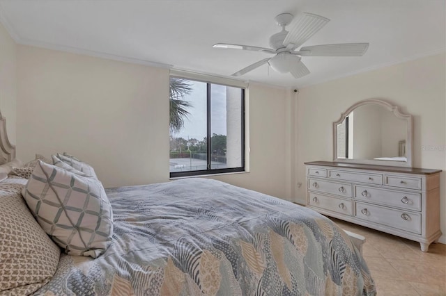 bedroom featuring ceiling fan, light tile patterned floors, and crown molding