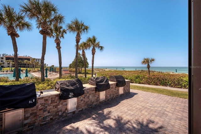 exterior space featuring area for grilling and a water view