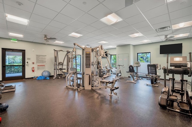 gym featuring a drop ceiling and plenty of natural light