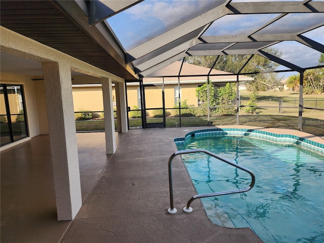 view of pool featuring a patio area and glass enclosure