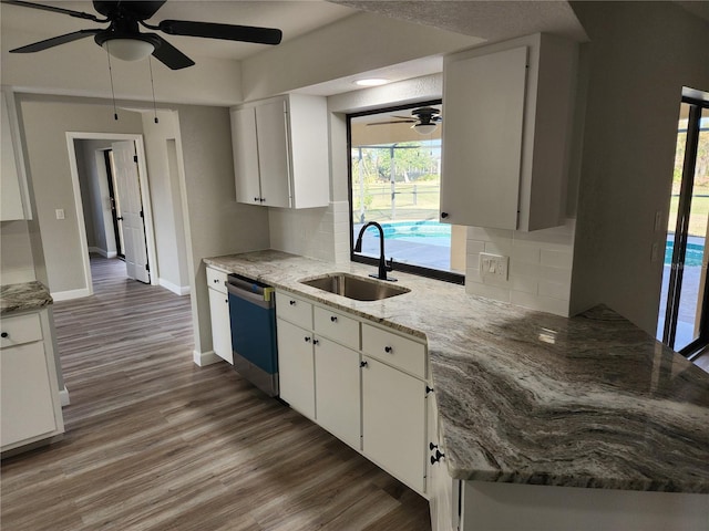 kitchen with sink, white cabinets, and stainless steel dishwasher