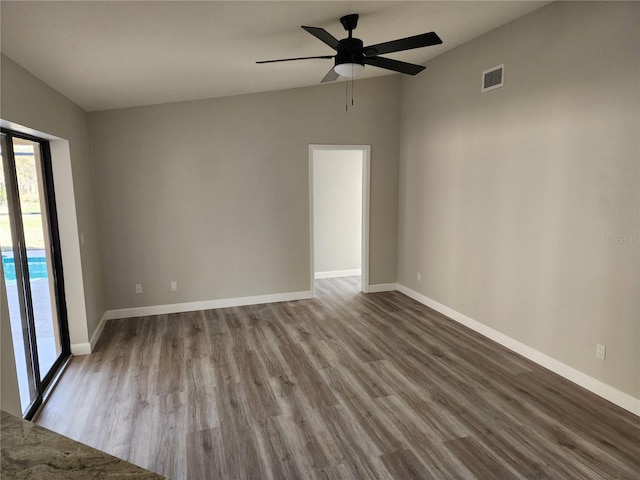 unfurnished room with ceiling fan, vaulted ceiling, and light wood-type flooring