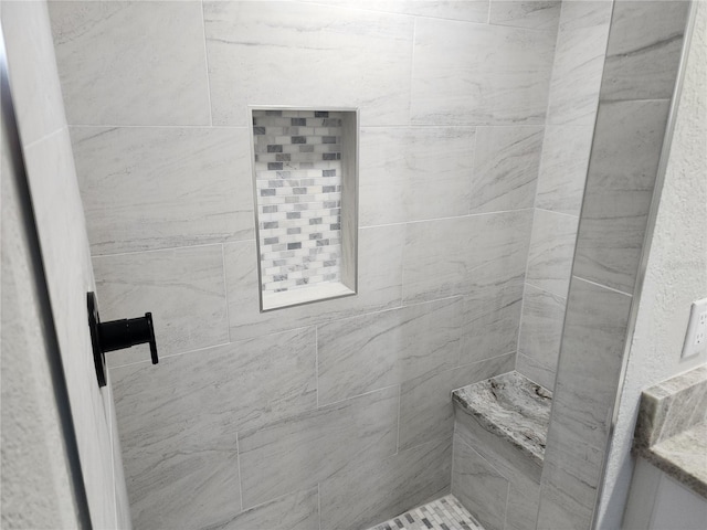 bathroom featuring a tile shower