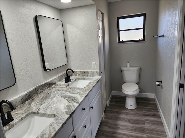 bathroom with vanity, hardwood / wood-style flooring, and toilet