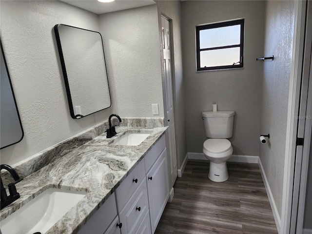 bathroom featuring hardwood / wood-style floors, vanity, and toilet