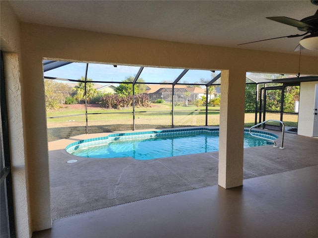 view of pool with ceiling fan, a lanai, a yard, and a patio