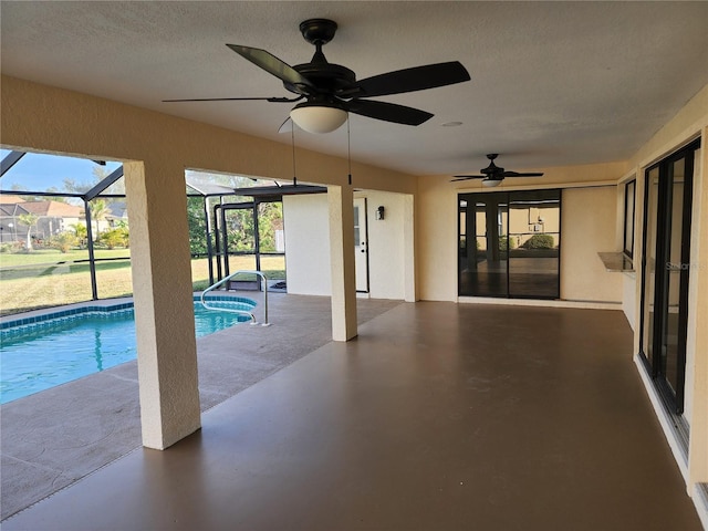 view of pool featuring glass enclosure, ceiling fan, and a patio