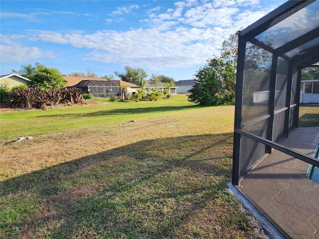 view of yard featuring glass enclosure