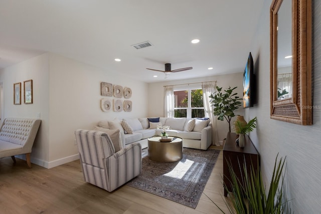 living room with light wood-type flooring and ceiling fan